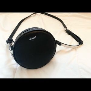 Mini Levi’s purse containing black/silver lining and silver interior.